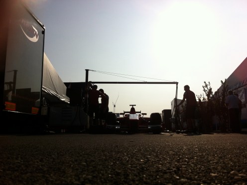 Mechanics stand over Mitch Evans’ Arden car, practicing stops. © Leigh O'Gorman